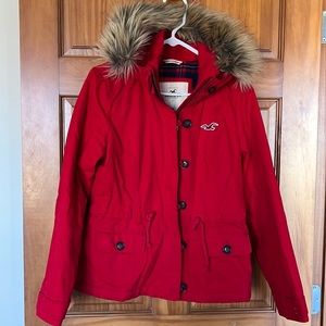 Hollister fall/winter jacket with fur hood. Red color with plaid lining, size M